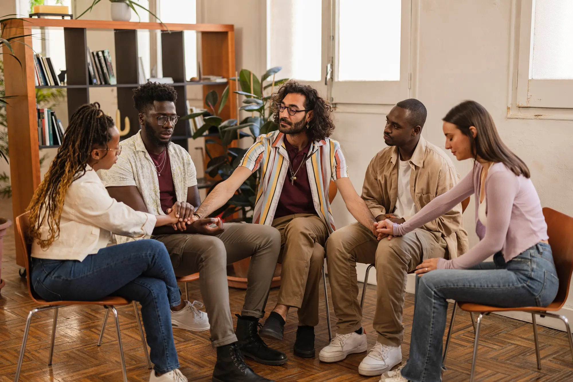 seminar talk therapy group of people sitting - diverse multiracial people talking in a group therapy